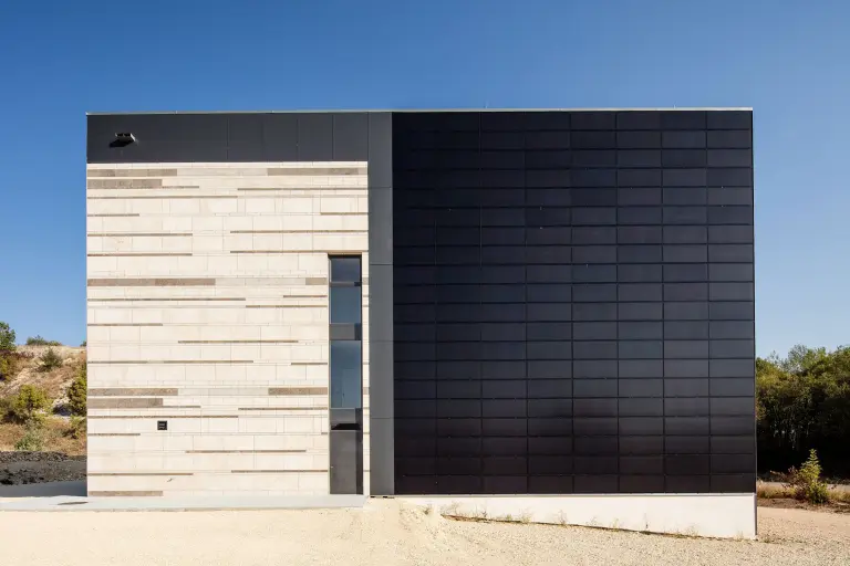 Inspiration zu Fassadenmaterialien: Außenaufnahme DAV Kletterzentrum, gedämmte Natursteinfassade