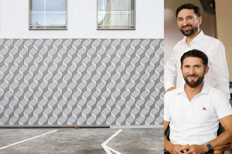 Gedämmte Fassade mit Keramikbekleidung und Putz, daneben Hendwerker