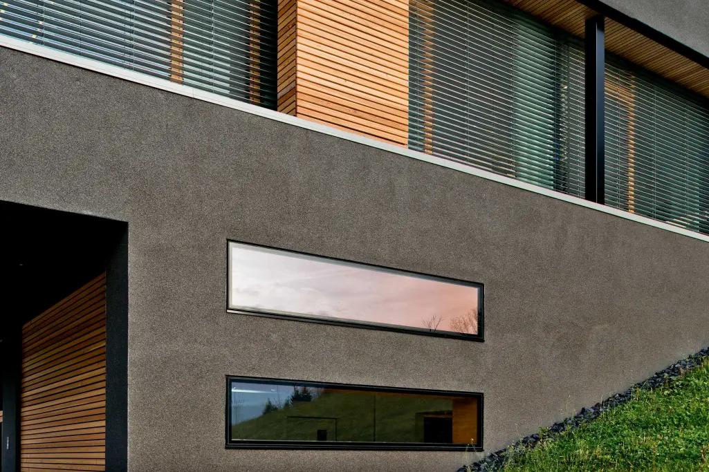 Buntsteinputz Sockel: unterer Bereich der Fassade eines Wohnhauses, anthrazitfarbener Sto-Mosaikputz