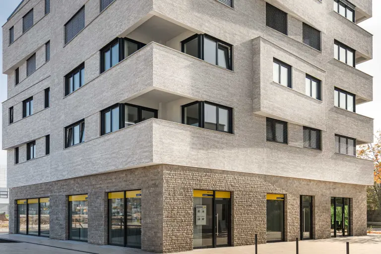 Außenaufnahme, Detailaufnahme einer Hausfassade, gedämmte graue Natursteinfassade, bekleidet mit StoStone Natursteinfliesen