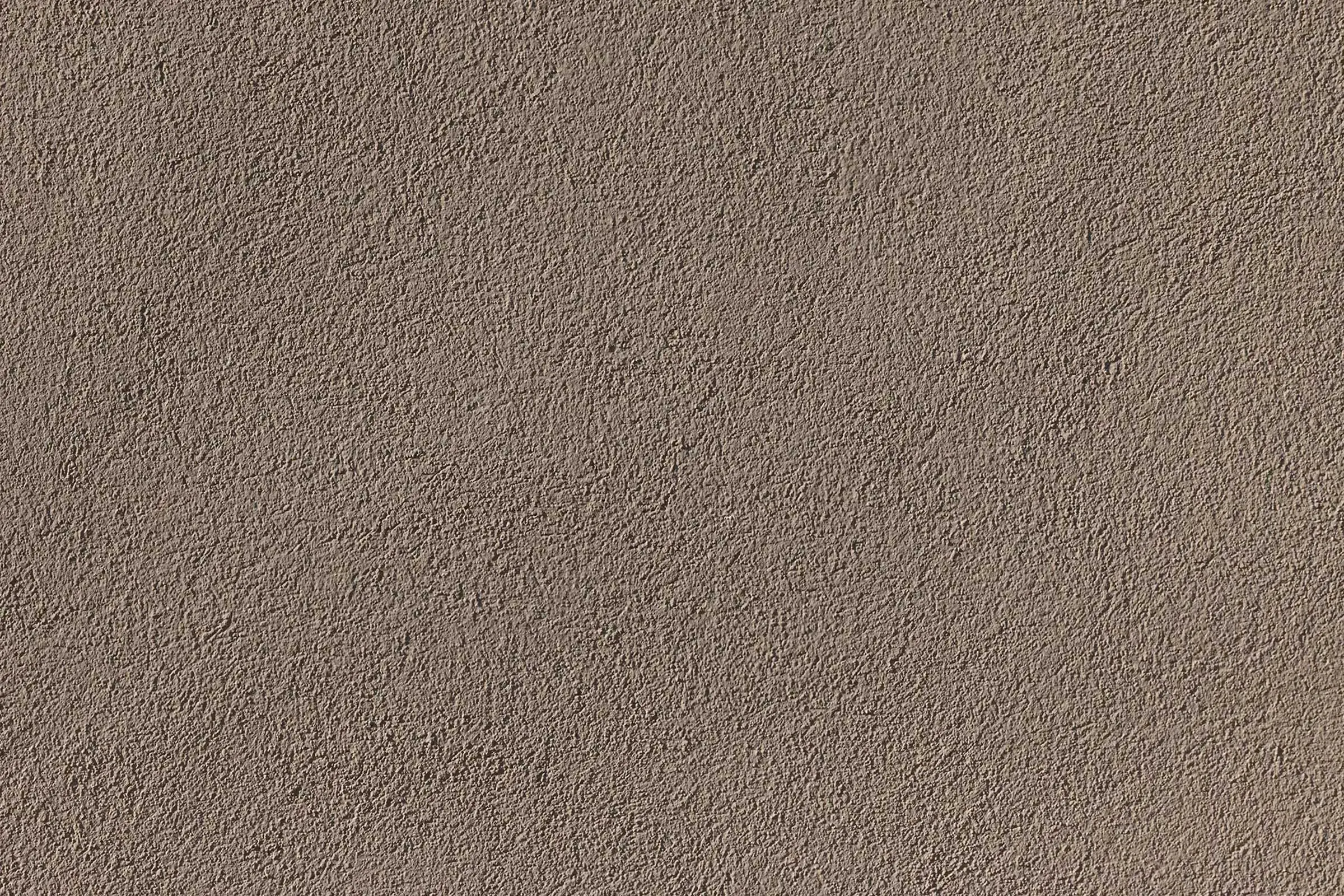 Wohn- und Geschäftsgebäude in Erdtönen mit Sto-Wärmedämmung und goldenen Architekturelementen