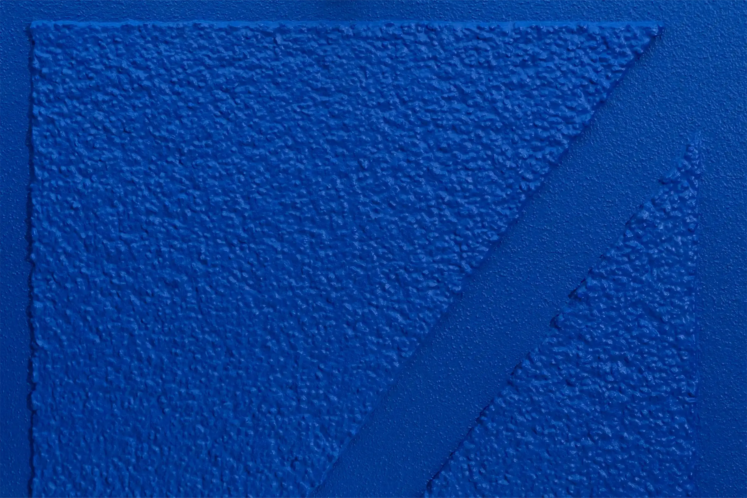 Detailaufnahme einer Putztechnik in Royalblaue, unterschiedliche Körnungsstärken und Geometrien