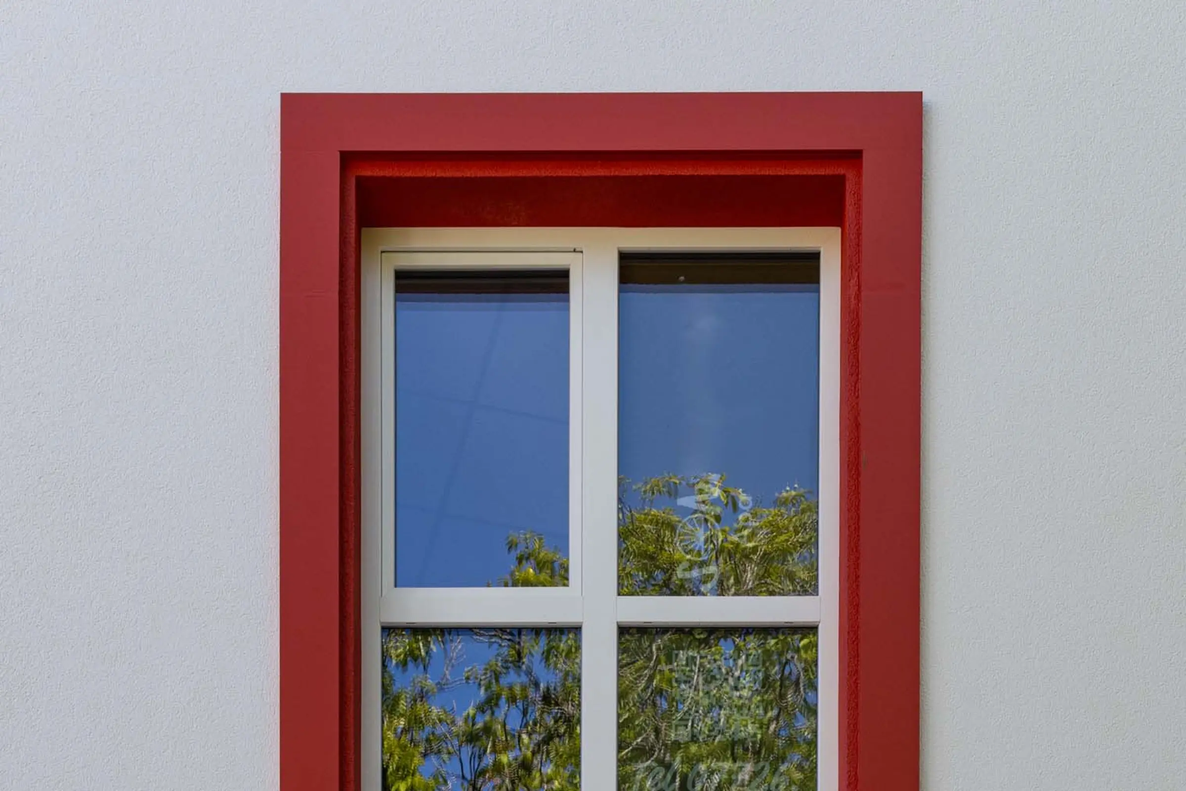 Detailaufnahme der bunten Fensterumrandungen aus StoDeco Fassadenelementen