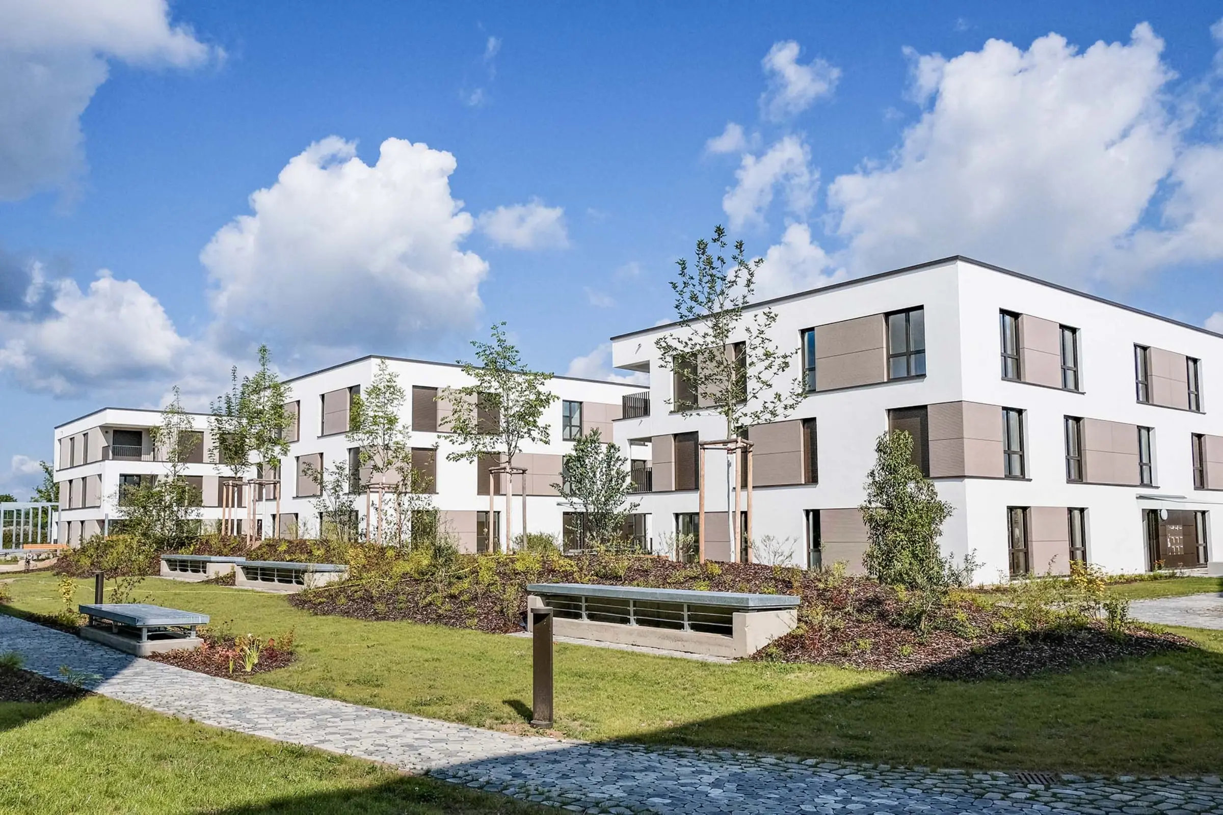 Aufnahme eines Wohnparks, weiße Fassaden mit beigen Akzenten, Neubau mit StoTherm Vario
