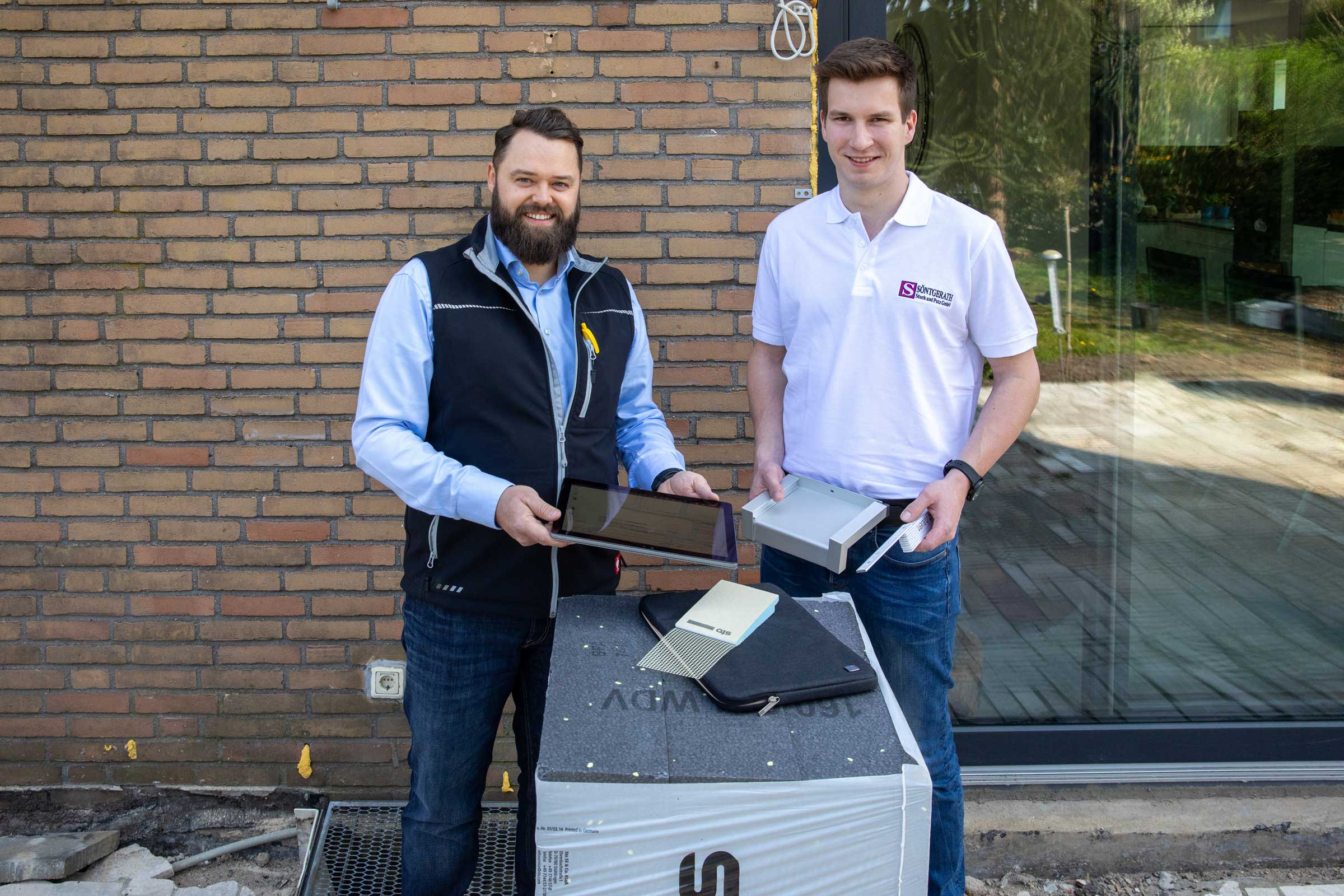 Stuckateurmeister Timo Söntgerath (rechts) berät sich bei der Fassadensanierung bei technischen Raff